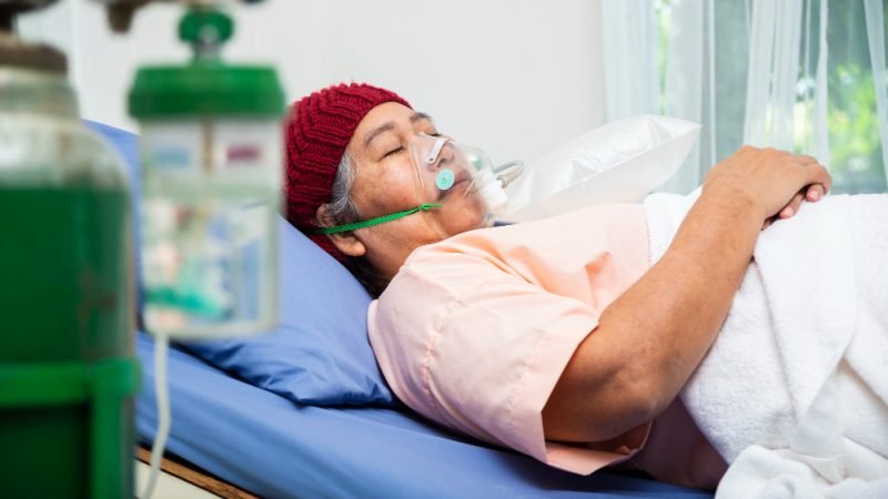 Older patient receiving oxygen therapy at Pacific Hyperbarics — Oceanside